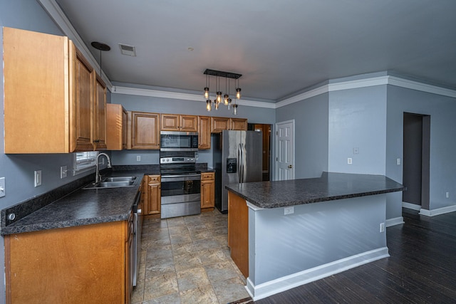 kitchen featuring sink, a center island, stainless steel appliances, pendant lighting, and ornamental molding