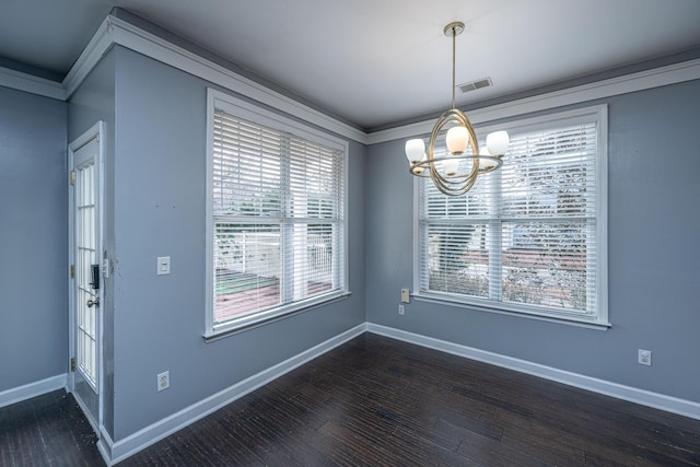 unfurnished dining area featuring ornamental molding, dark hardwood / wood-style flooring, and a notable chandelier