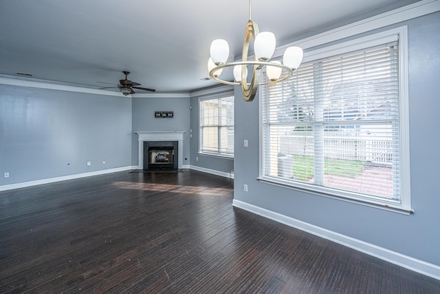 unfurnished living room featuring dark hardwood / wood-style flooring, ceiling fan with notable chandelier, and crown molding