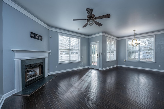 unfurnished living room with ceiling fan with notable chandelier, dark hardwood / wood-style flooring, crown molding, and a wealth of natural light