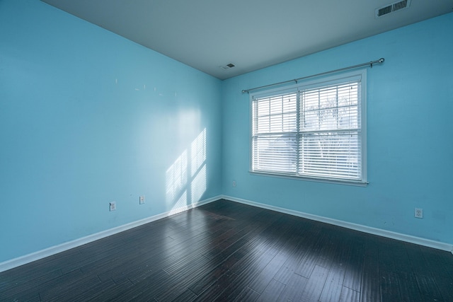 unfurnished room with dark hardwood / wood-style floors