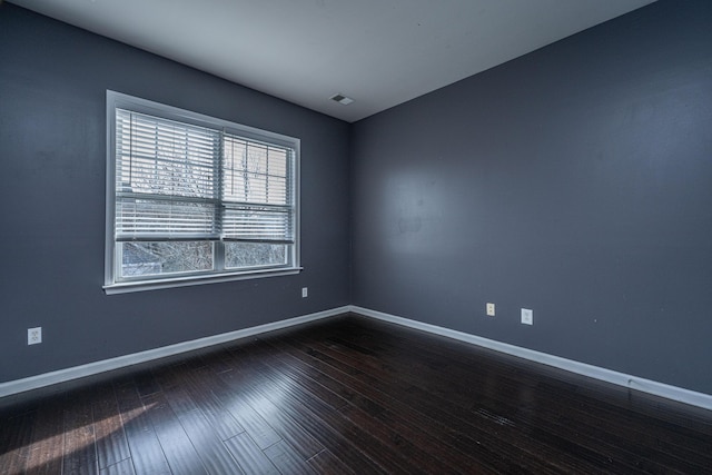 spare room with dark hardwood / wood-style floors