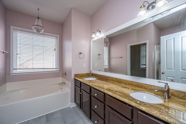 bathroom featuring tile patterned floors, vanity, and separate shower and tub