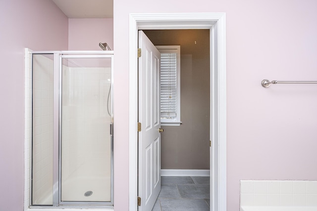 bathroom with tile patterned floors and an enclosed shower