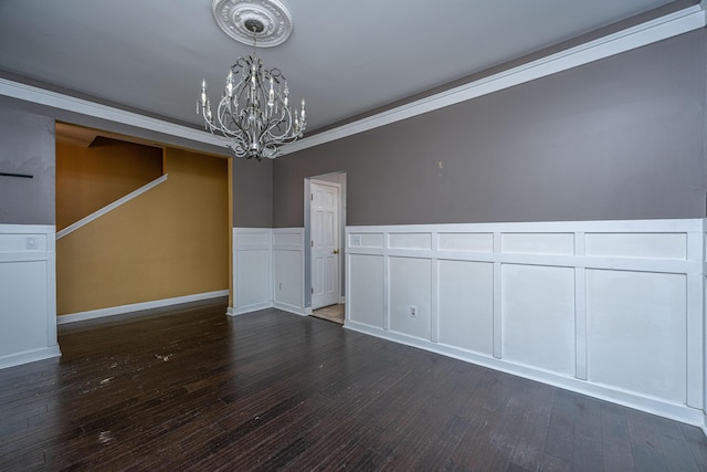 unfurnished dining area with dark hardwood / wood-style flooring, ornamental molding, and a notable chandelier