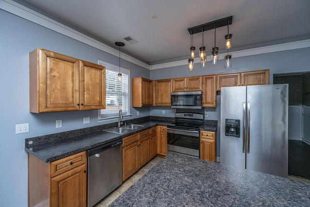 kitchen featuring appliances with stainless steel finishes, decorative light fixtures, crown molding, and sink