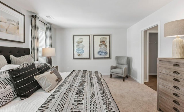 bedroom with a spacious closet and carpet