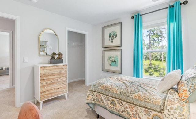 bedroom featuring light carpet and a closet