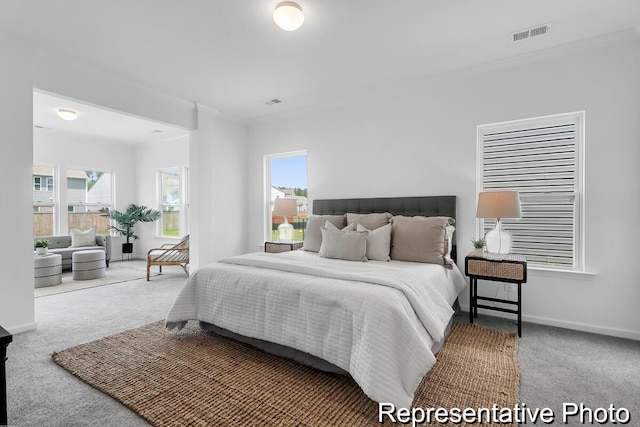 bedroom with visible vents, multiple windows, carpet, and baseboards