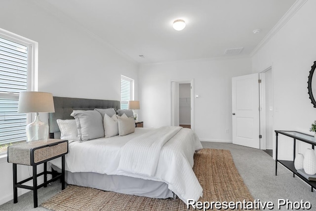 carpeted bedroom featuring visible vents, baseboards, and ornamental molding