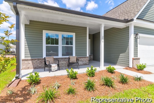 view of patio / terrace with a garage and a porch