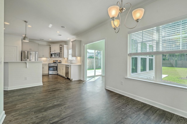 211 Saxony Loop, Summerville, SC 29486 - kitchen featuring appliances with stainless steel finishes, light countertops, decorative backsplash, dark wood-style floors, and ornamental molding