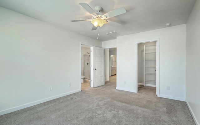211 Saxony Loop, Summerville, SC 29486 - unfurnished bedroom featuring a walk in closet, carpet, baseboards, ensuite bath, and a closet
