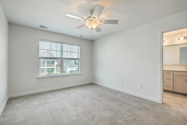 211 Saxony Loop, Summerville, SC 29486 - unfurnished bedroom featuring light colored carpet, baseboards, connected bathroom, and a ceiling fan