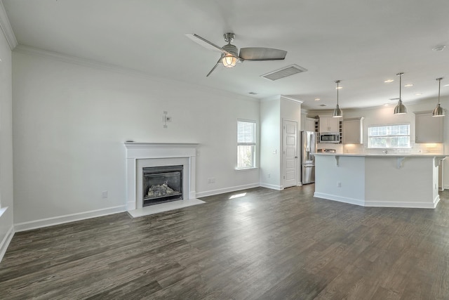 211 Saxony Loop, Summerville, SC 29486 - unfurnished living room featuring ornamental molding, ceiling fan, dark wood-style floors, a glass covered fireplace, and recessed lighting