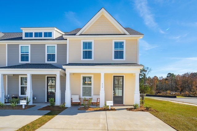 view of front of house featuring covered porch and a front yard