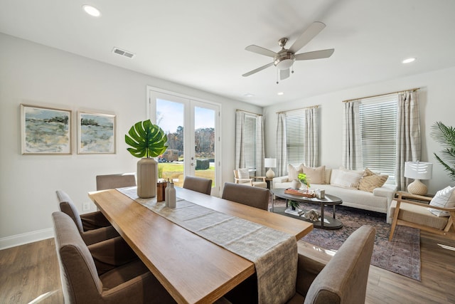 dining space with ceiling fan, dark wood-type flooring, and french doors