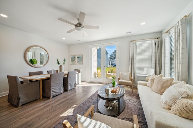 living room with dark hardwood / wood-style floors, ceiling fan, and french doors