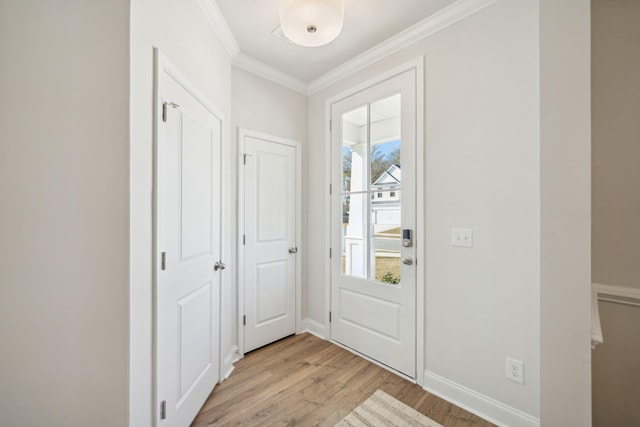 foyer with light hardwood / wood-style floors and ornamental molding