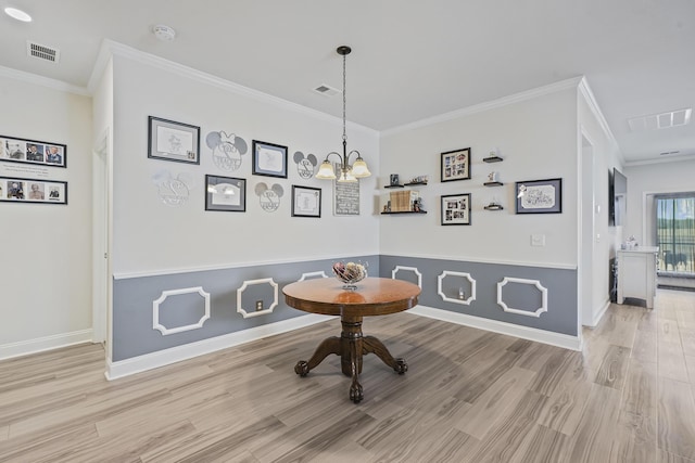 dining room with ornamental molding, baseboards, visible vents, and light wood finished floors