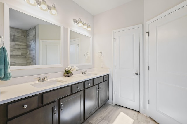 full bathroom featuring a sink and double vanity