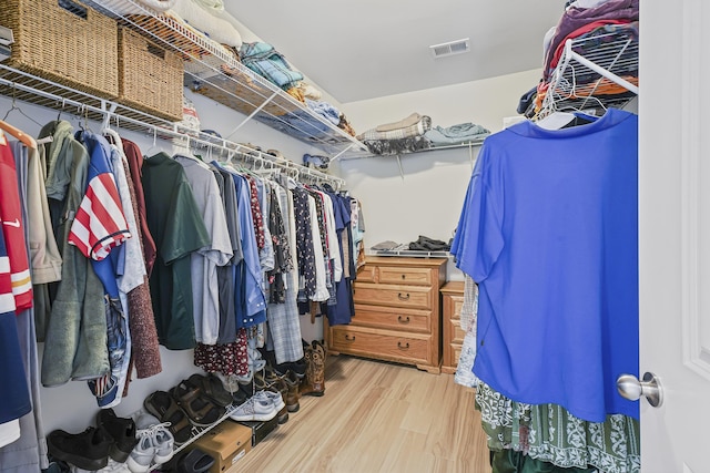 walk in closet featuring wood finished floors and visible vents