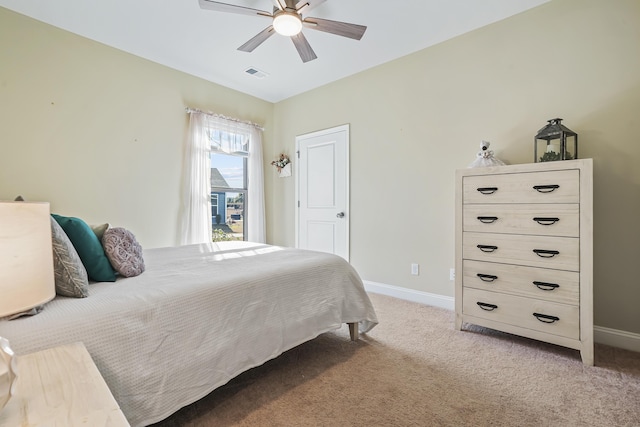 bedroom featuring baseboards, visible vents, a ceiling fan, and light colored carpet