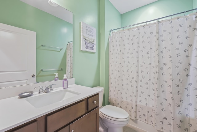 bathroom with shower / bath combination with curtain, vanity, and toilet