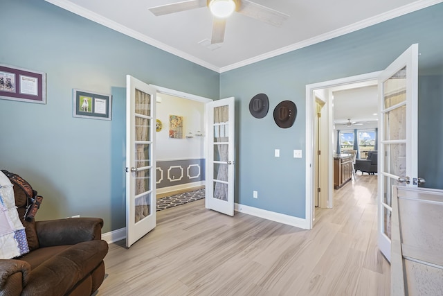 living area featuring french doors, baseboards, crown molding, and light wood finished floors