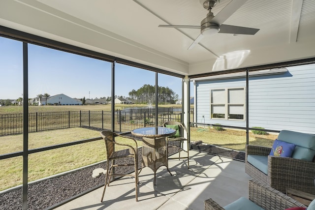 sunroom featuring a ceiling fan