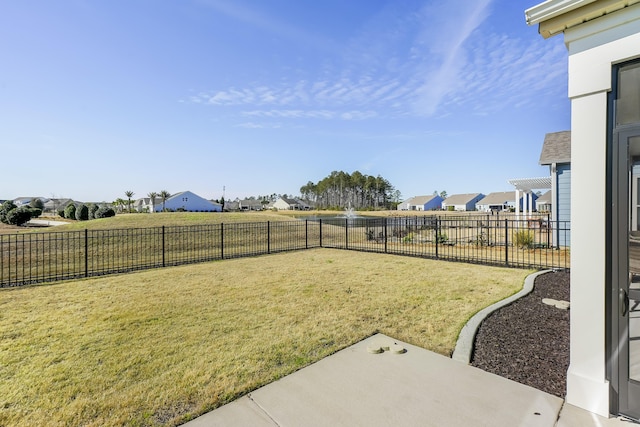 view of yard with a fenced backyard and a residential view