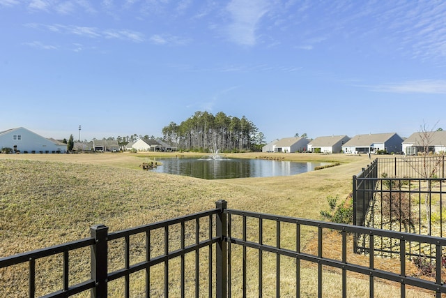 view of water feature featuring a residential view and fence