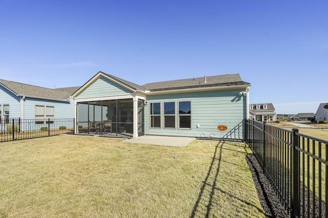 rear view of property with a sunroom, a fenced backyard, a yard, and a patio