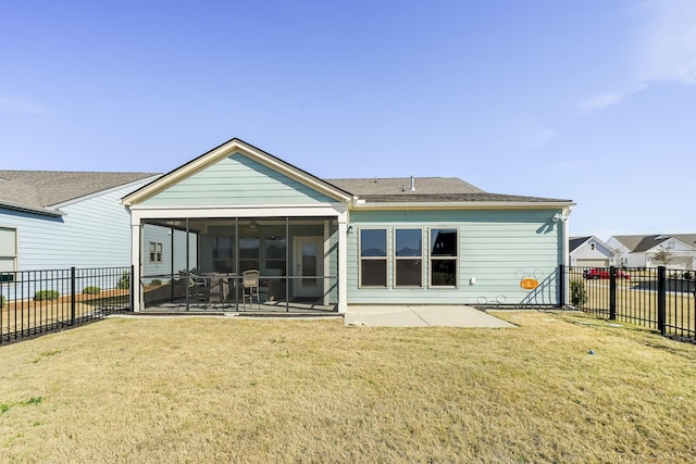 back of property with a patio area, a sunroom, a fenced backyard, and a yard