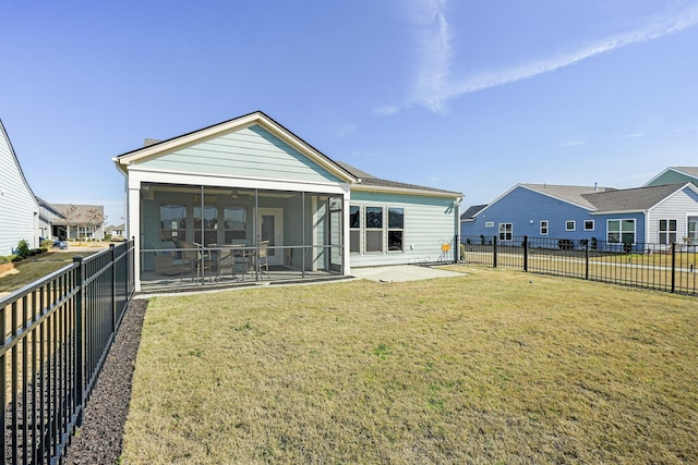 back of property featuring a patio area, a sunroom, a fenced backyard, and a yard