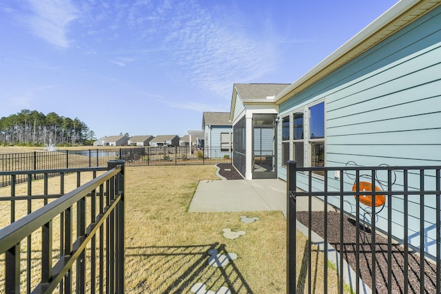 view of yard featuring a patio, a fenced backyard, and a residential view