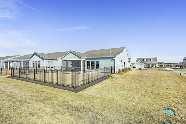 back of property featuring a residential view, a fenced backyard, a lawn, and a patio