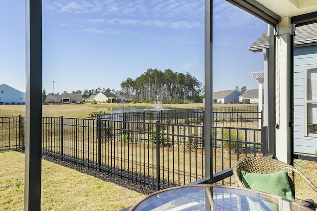 sunroom / solarium featuring a water view