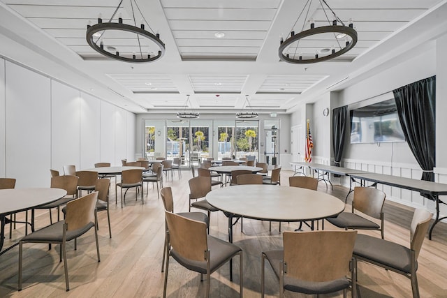 dining room featuring french doors, coffered ceiling, and light wood-style flooring