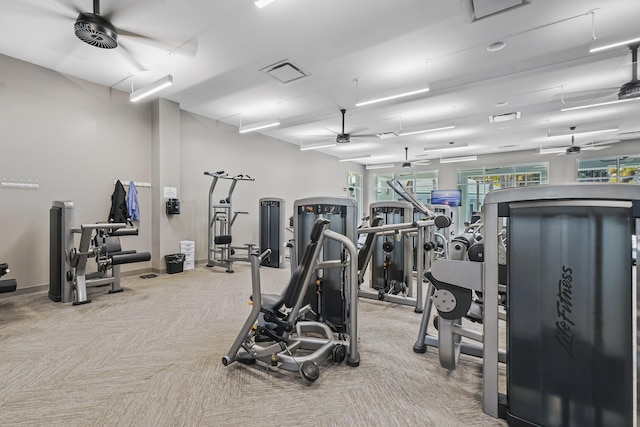 exercise room with carpet flooring, ceiling fan, visible vents, and baseboards