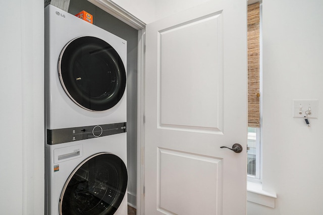 laundry area with stacked washing maching and dryer