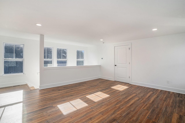 empty room with dark wood-type flooring