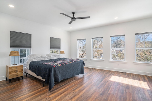 bedroom with dark hardwood / wood-style flooring and ceiling fan