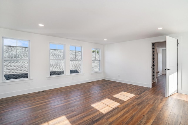 unfurnished room featuring dark wood-type flooring