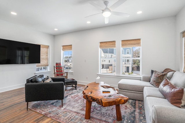 living room with wood-type flooring and ceiling fan