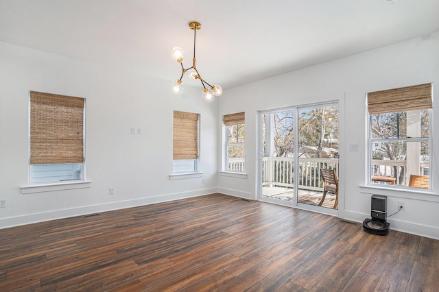 interior space featuring a notable chandelier and dark wood-type flooring