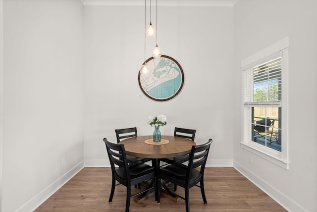 dining space with wood finished floors and baseboards