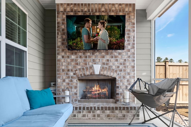 living area featuring wood walls and an outdoor brick fireplace