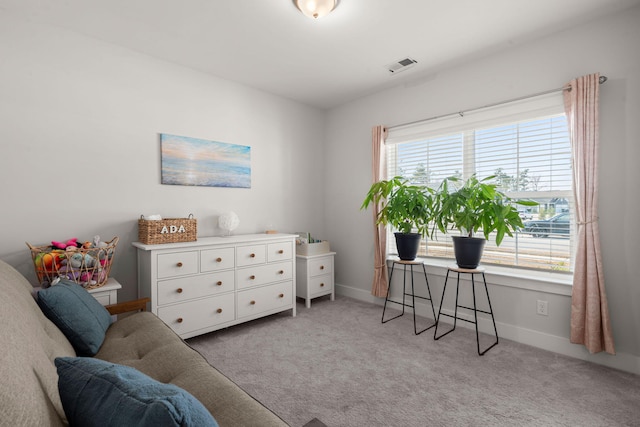 sitting room featuring baseboards, visible vents, and light colored carpet