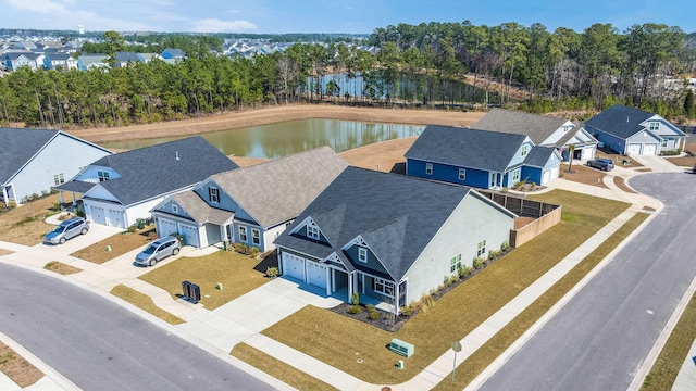 drone / aerial view featuring a water view and a residential view